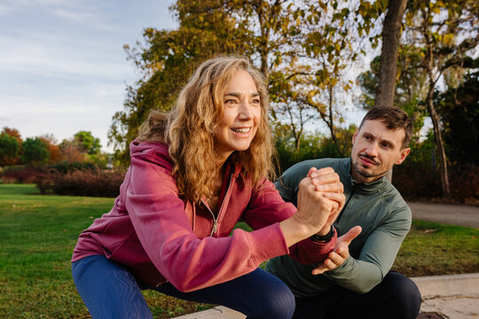 Senior woman doing squats as part of a health improvement program