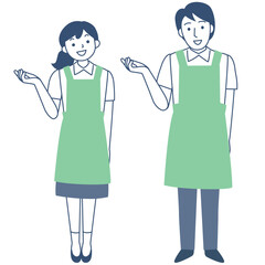 エプロンを着けて案内する若い女性と男性