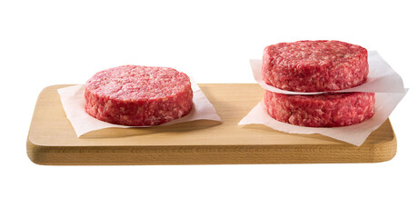 Raw minced beef patties for hamburgers in a cutting board isolated on white background.