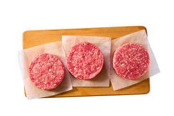 Raw minced beef patties for hamburgers in a cutting board isolated on white background, top view.