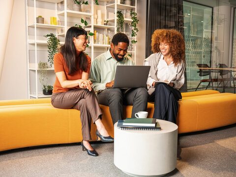 Friendly Office Team Shares Ideas During A Casual Meeting