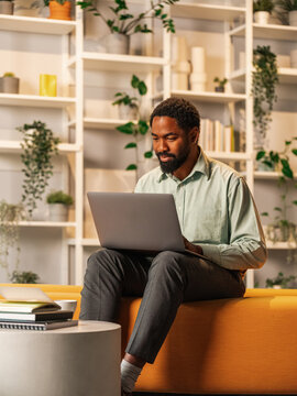 Professional Man Working On Laptop In A Cozy Modern Office 
