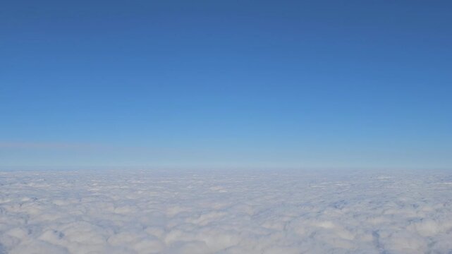 Soft Cumulus Clouds Floating Beneath Blue Sky, Aircraft Window View
