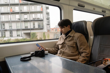 Young Student Relaxing on the Train While Reading and Texting