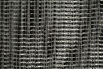 Woven grayish background with metallic shiny material.