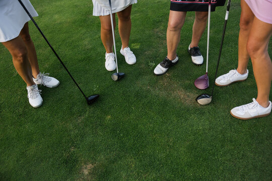 Candid group of friends on a golf course, ready to play a round