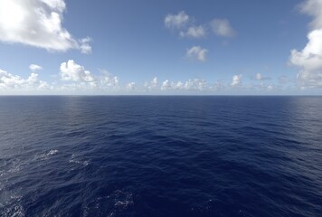 Fototapeta premium Panoramic view of a vast, deep blue ocean merging with a partly cloudy, light blue sky
