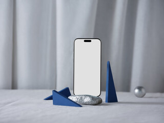 Smartphone mockup with blue geometric shapes and a silver stone