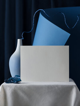 Elegant still life composition with a blank card and vase