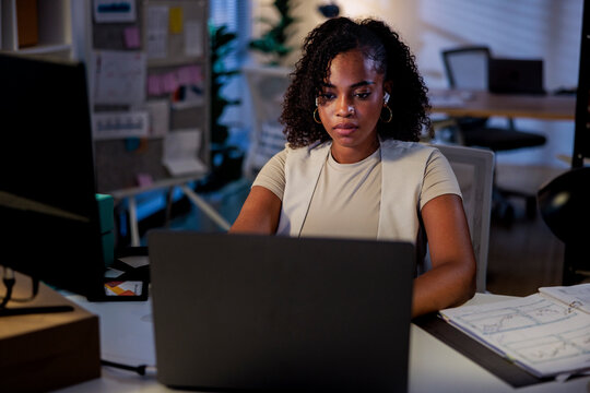 Woman working late at the office on her laptop.