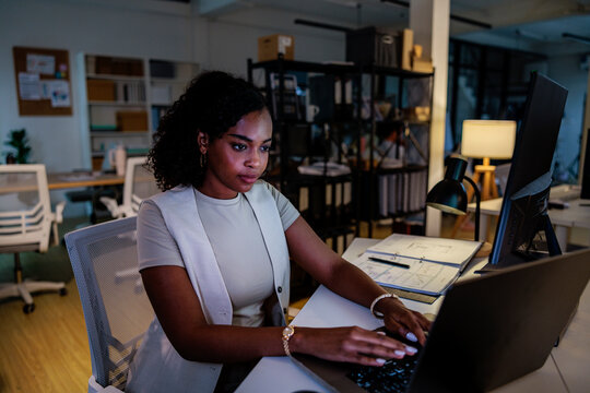 Woman working late at the office on her laptop.