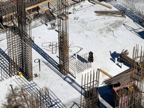 Construction site floor with rebar cages and formwork wood