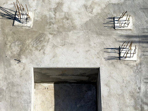 Fresh concrete surface with rebar anchors and rectangular niche
