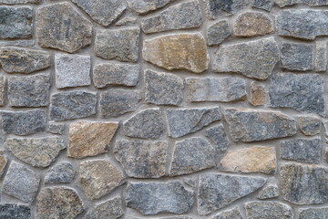 A close-up, full-frame shot of a rustic, textured natural stone wall featuring Wilmington Complex (Blue Gneiss Rocks) in Wilmington Delaware