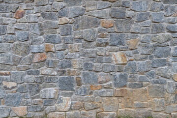A close-up, full-frame shot of a rustic, textured natural stone wall featuring Wilmington Complex (Blue Gneiss Rocks) in Wilmington Delaware
