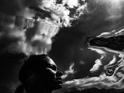 Reflection of a person in water during daylight