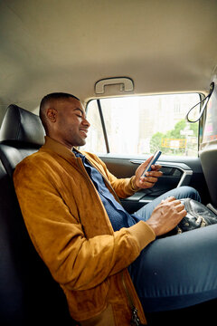Passenger uses phone in taxi