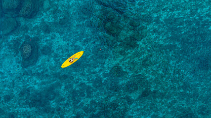 Aerial view of a kayak in the blue sea .man kayaking he does water sports activities