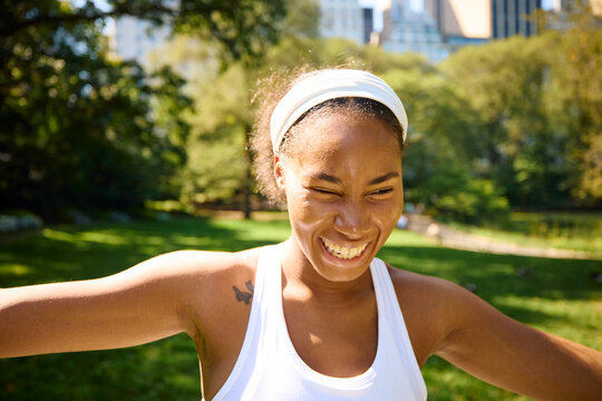 Happy woman working out in the park