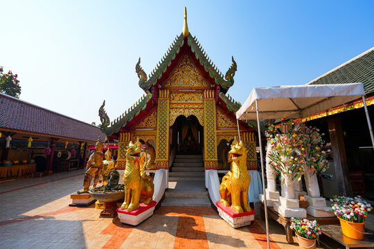 Ornate golden facade of the main Viharn at Wat Phra That Doi Kham temple on the mountain side of Chiang Mai, Northern Thailand