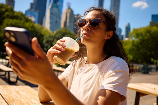 Woman casually enjoys coffee in NYC