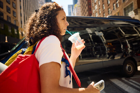 Woman drinks on the street