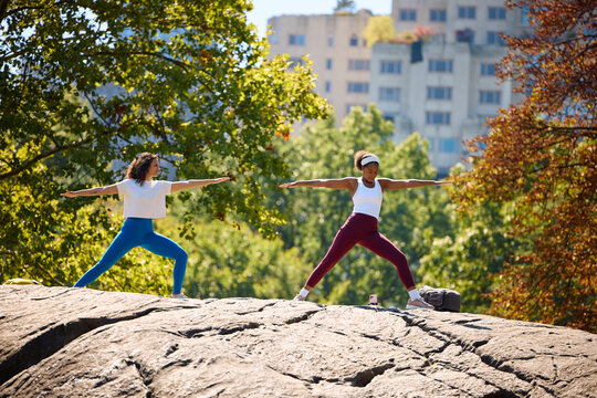 Women practice yoga in the park