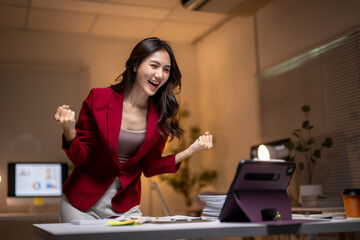 Businesswoman celebrating success and achieving goals at office