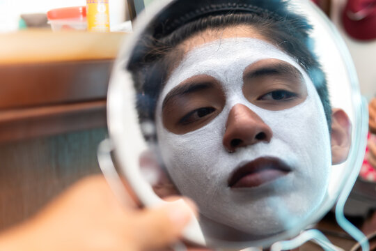 Person preparing face paint for dia de muertos