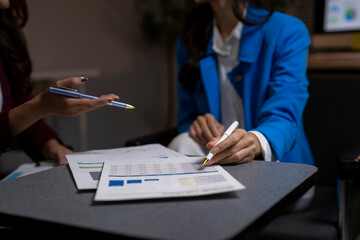 Businesswomen analyzing financial data during office meeting
