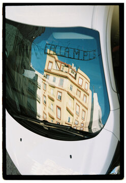 Fallas street decorations reflected in car windshield in Valencia