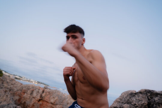 Young fighter training and throwing punches
