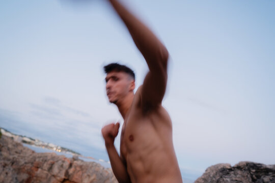 Young fighter training and throwing punches