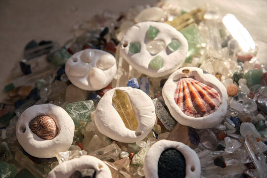 Unique homemade clay ornaments with materials in the sunlight.