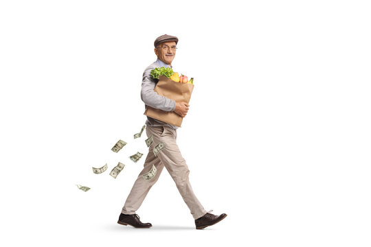 Senior man losing money while carrying a bag of groceries