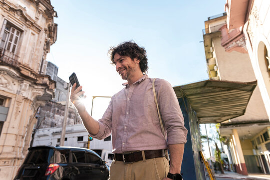 Joyful man video chatting feeling travel freedom