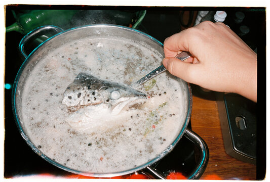 Fish head boiling in pot with spices