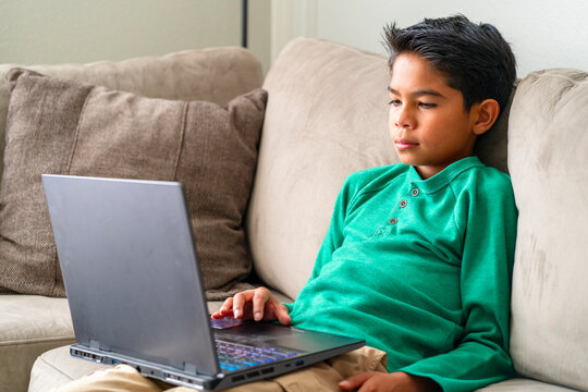 boy browsing laptop