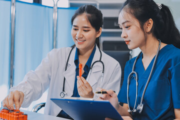 Medical team meeting analyzing blood test results in hospital laboratory. Doctors and scientists in lab coats are having a discussion about blood test result, holding test tubes and taking notes.