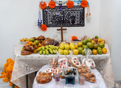 Day of the dead ofrenda preparing altar for celebration