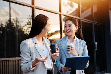Business people walking and talk to each other in front of modern office