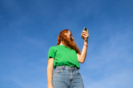 Happy woman with phone blue skye