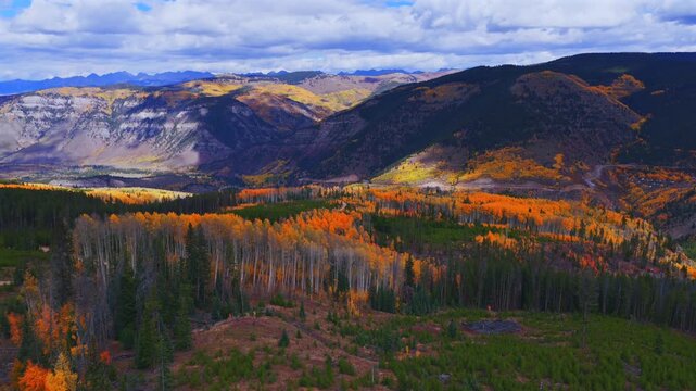 Minturn Red Cliff Vail Mount of the Holy Cross Wilderness Sawatch Gore Range aerial drone Fall Autumn sun cloudy morning Rocky Mountains Colorado colorful Aspen trees windy dirt road forward pan up