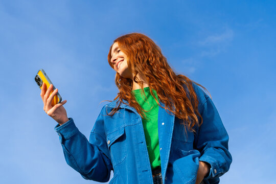 Happy woman with phone blue skye