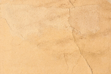 old vintage paper on full frame surface, weathered grainy texture with warm beige matte finish and visible fibers with copy space, historical background and scrapbook concept