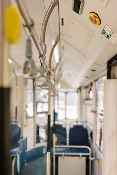 Empty City Bus Interior Shows Seating and Handrails