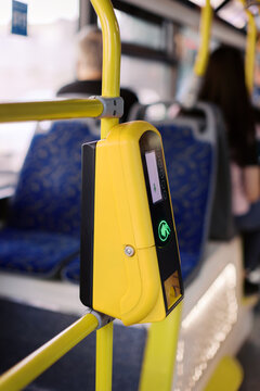 Bus Fare Validator on Yellow Pole During Transit