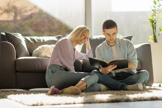 Happy young couple looking at a book