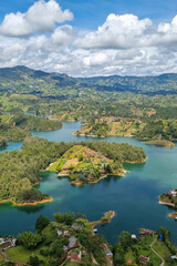 Fototapeta premium Panoramic view of Guatape lake area, (Penol) Colombia, South America cloudy day amazing tree area in middle of lake 9