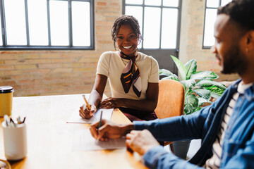 Business professionals writing during an important meeting